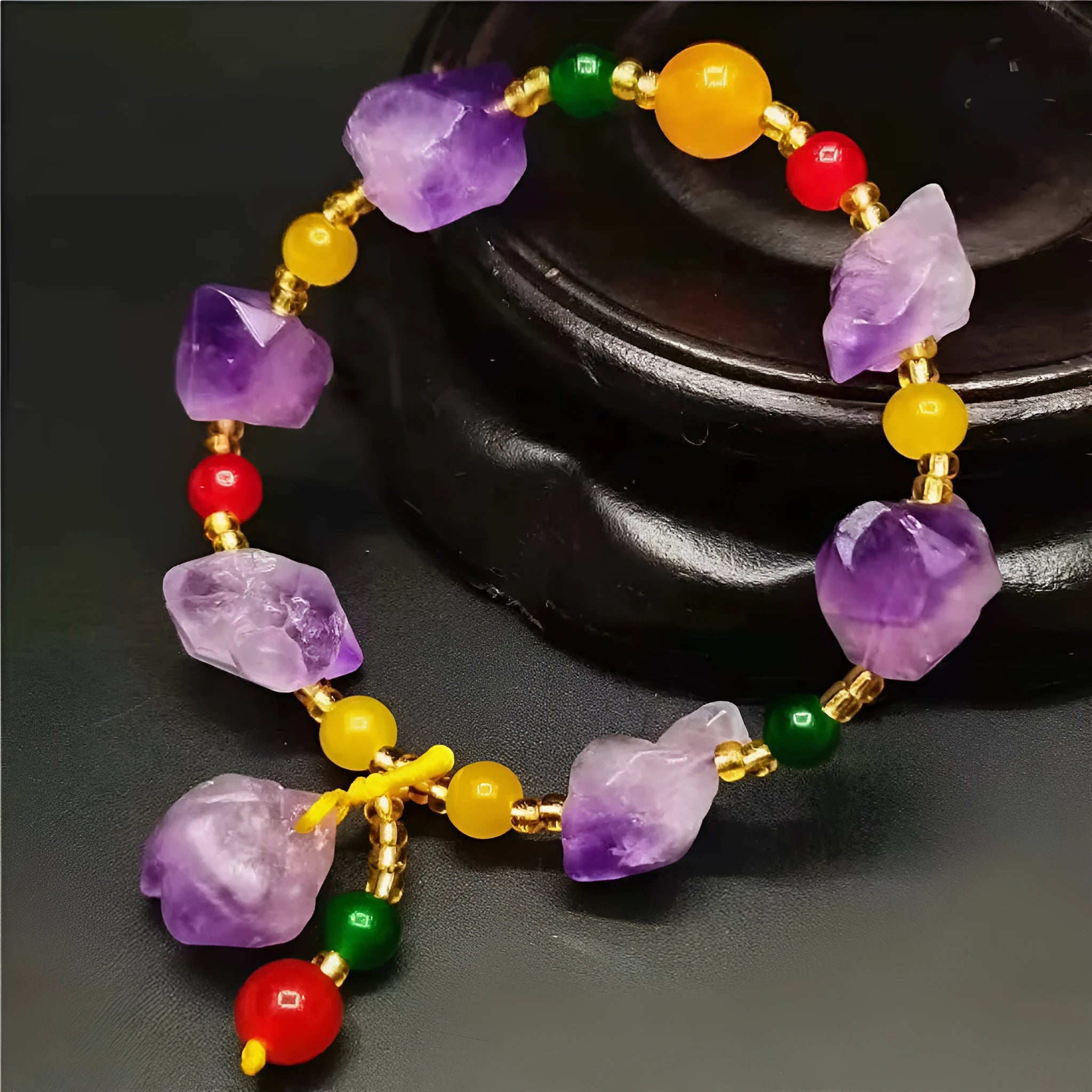 Close-up of a natural-shaped amethyst bead bracelet for women with a fu charm.