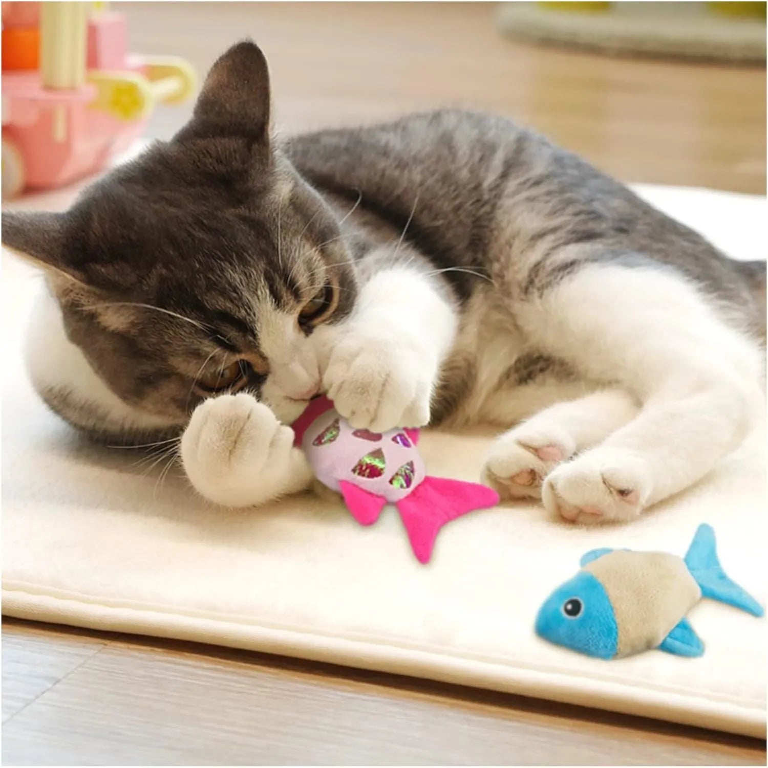 Two soft plush catnip fish toys for cats with crinkle sound, available in blue, orange, and pink.
