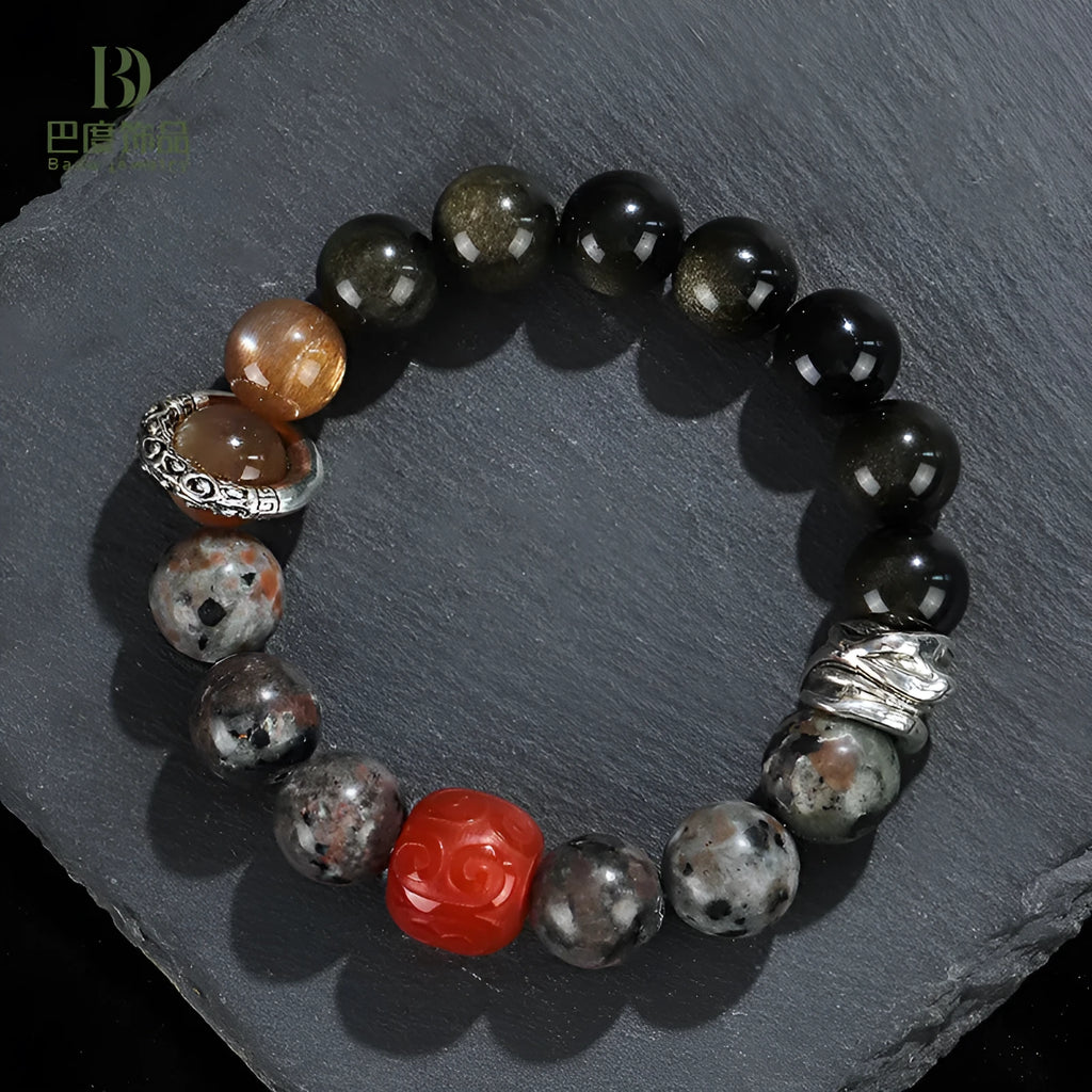 Gold obsidian flame stone and red agate unisex bracelet with original Wukong design on neutral background