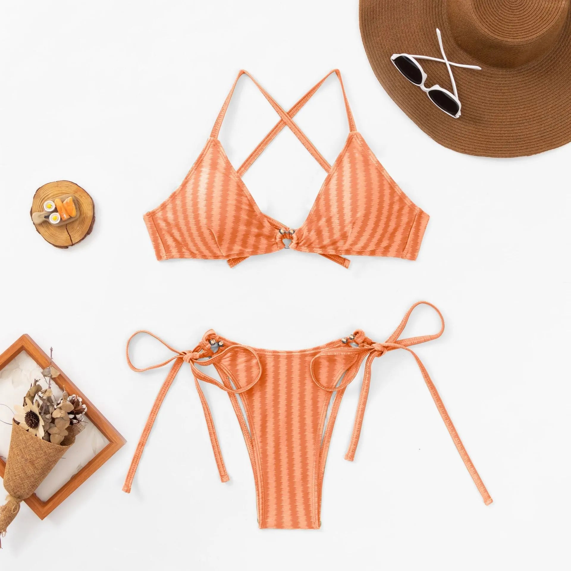 Women's red jacquard lace-up bikini top with matching split briefs on a neutral background.