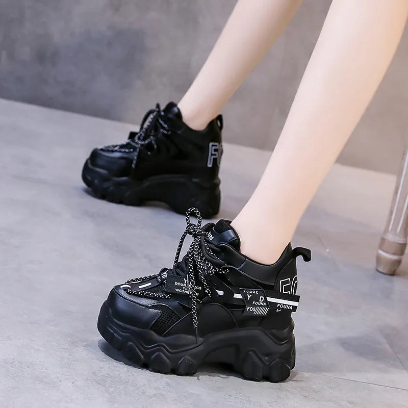 White and black women's low-top platform sports shoes with mesh upper and cross strap.