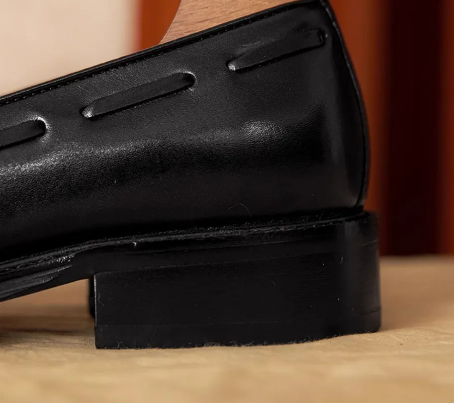 Men's black leather slip-on loafers with fringed detail and rubber sole
