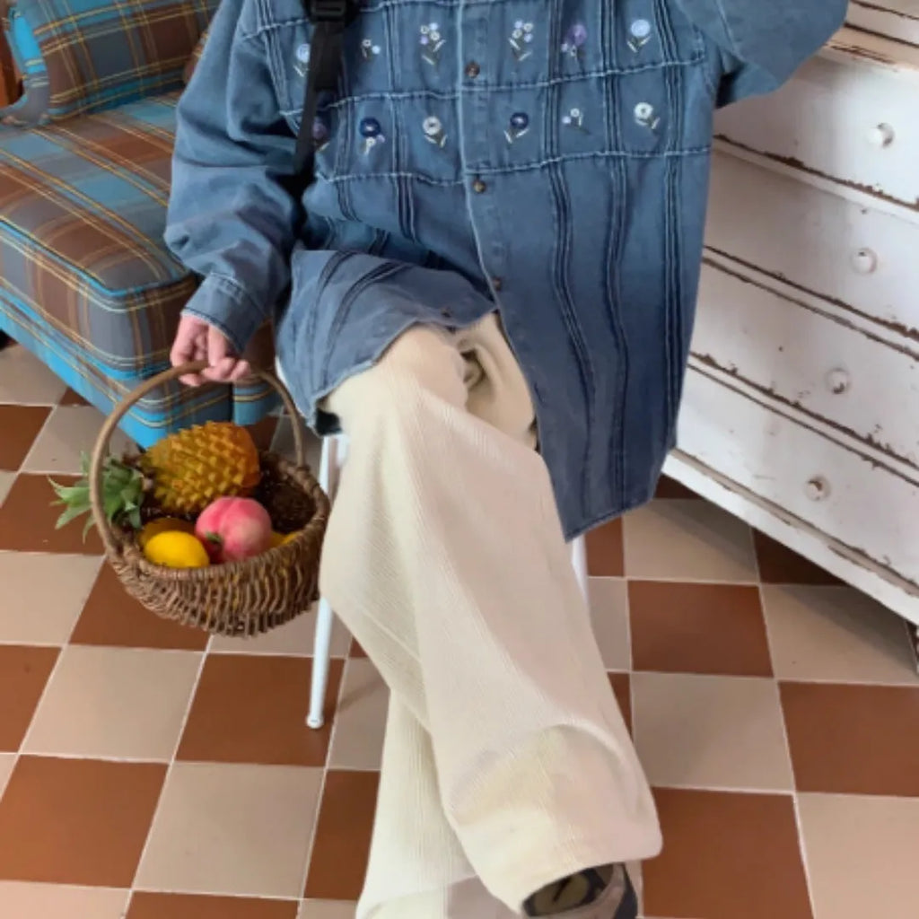 Washed blue long sleeved denim shirt with small floral pattern and pleated details on front