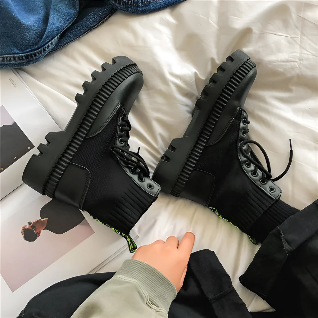 Men's black platform ankle boots with zip, frosted leather upper, and rubber sole.