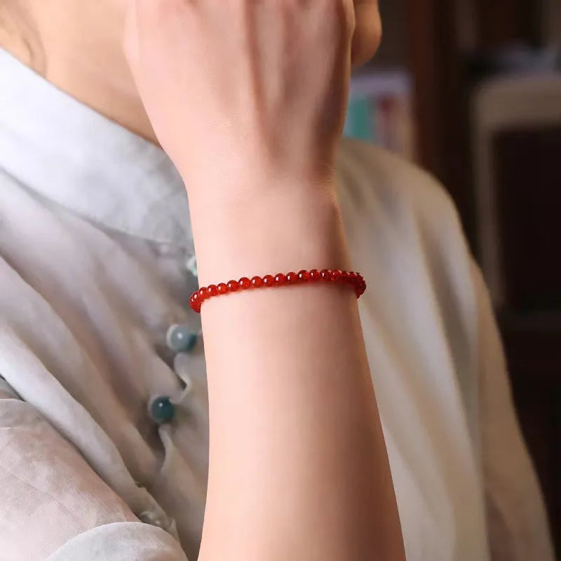 Ultra-thin red agate calm small bracelet for women classic style on neutral background