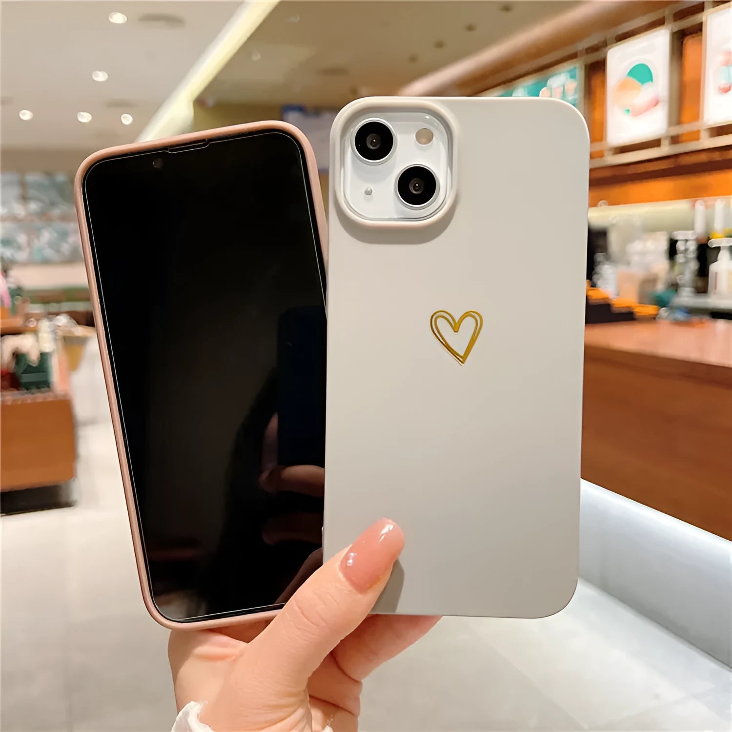 Simple cute grey silicone iPhone case with hot stamping design on a table.