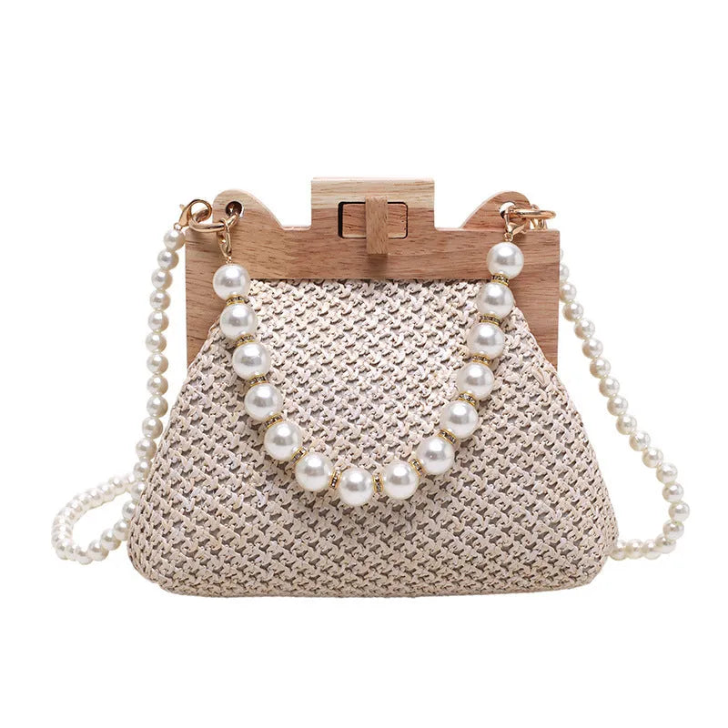 Women's woven straw shoulder bag with pearl chain detailing and multiple interior compartments