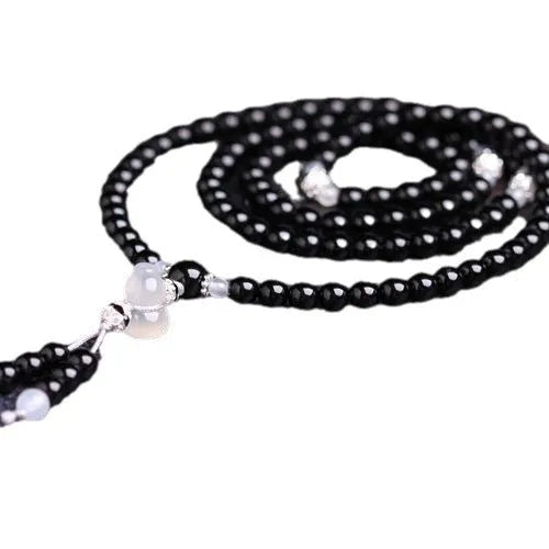 Natural black agate 108 beads bracelet on a flat surface, geometric beads, unisex fashion OL style