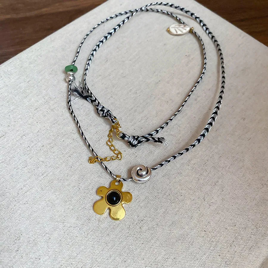 Stone shell beaded flower pendant necklace on alloy clavicle chain with electroplated finish in silver and gold tones