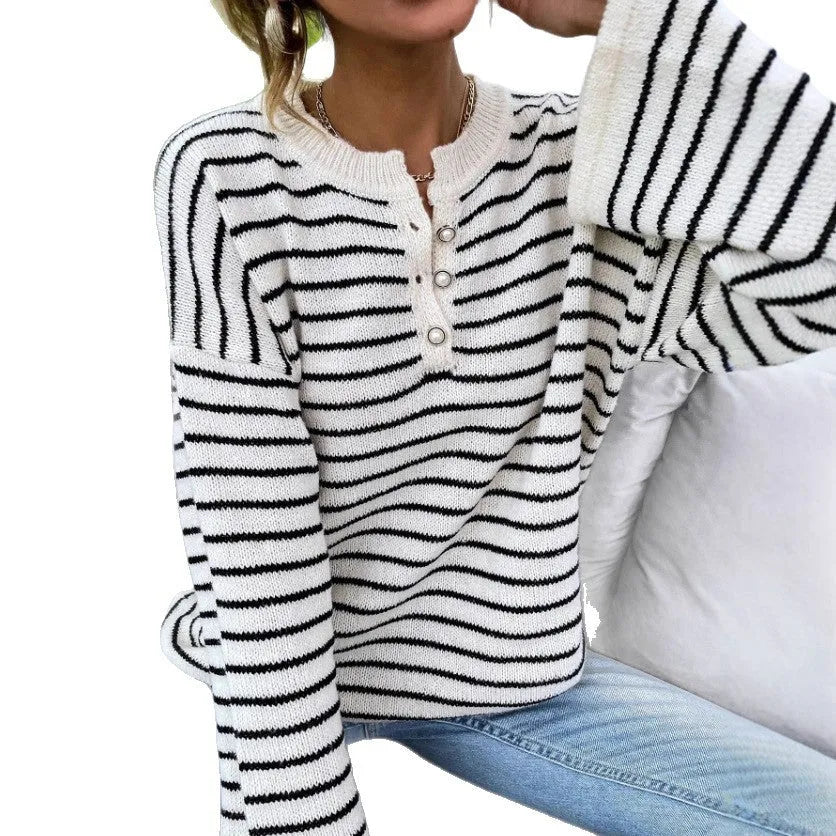 Women's black and white striped loose top with drop-shoulder sleeves and button details