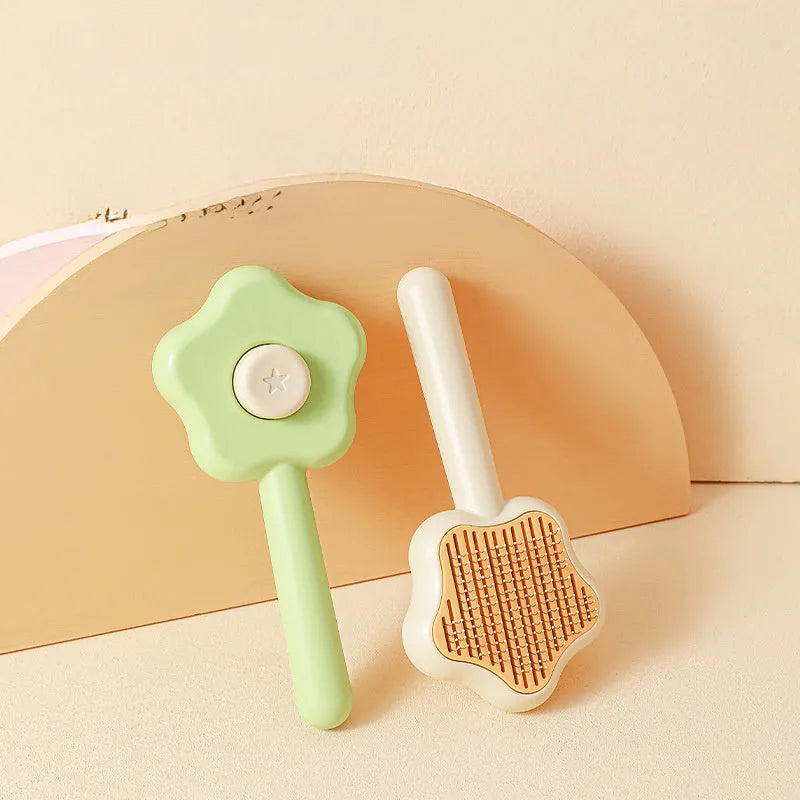 Green self-cleaning stainless steel pet comb for grooming cats and dogs on a white background
