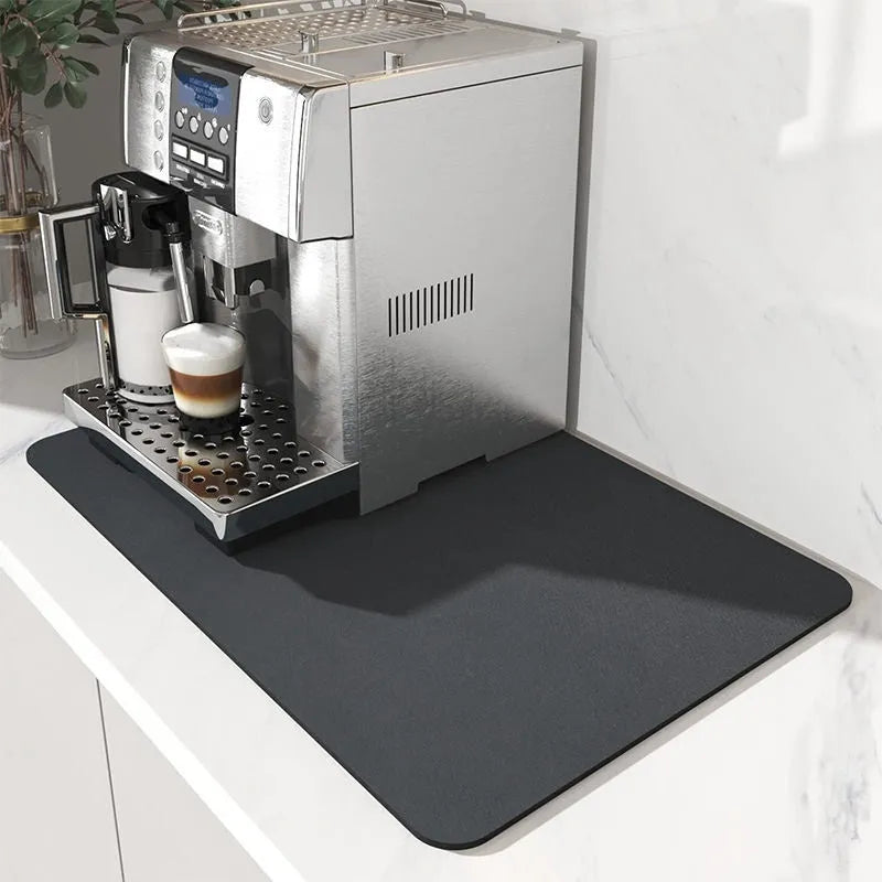 Super absorbent dish drying mat in black PU leather with non-slip rubber backing on a kitchen counter