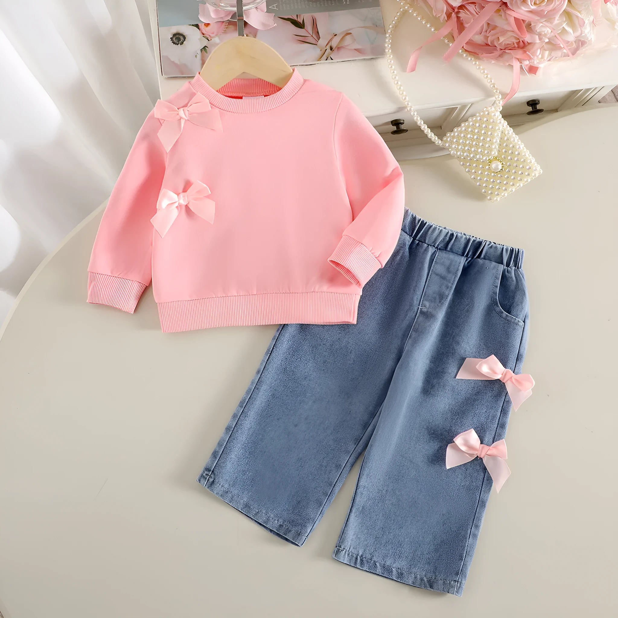 Pink two-piece baby girls outfit with long-sleeved sweater and trousers in cotton