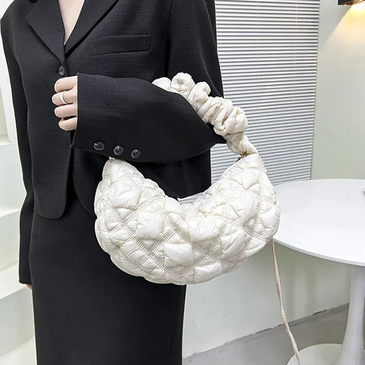 Women's light beige nylon underarm messenger bag with a long shoulder strap.