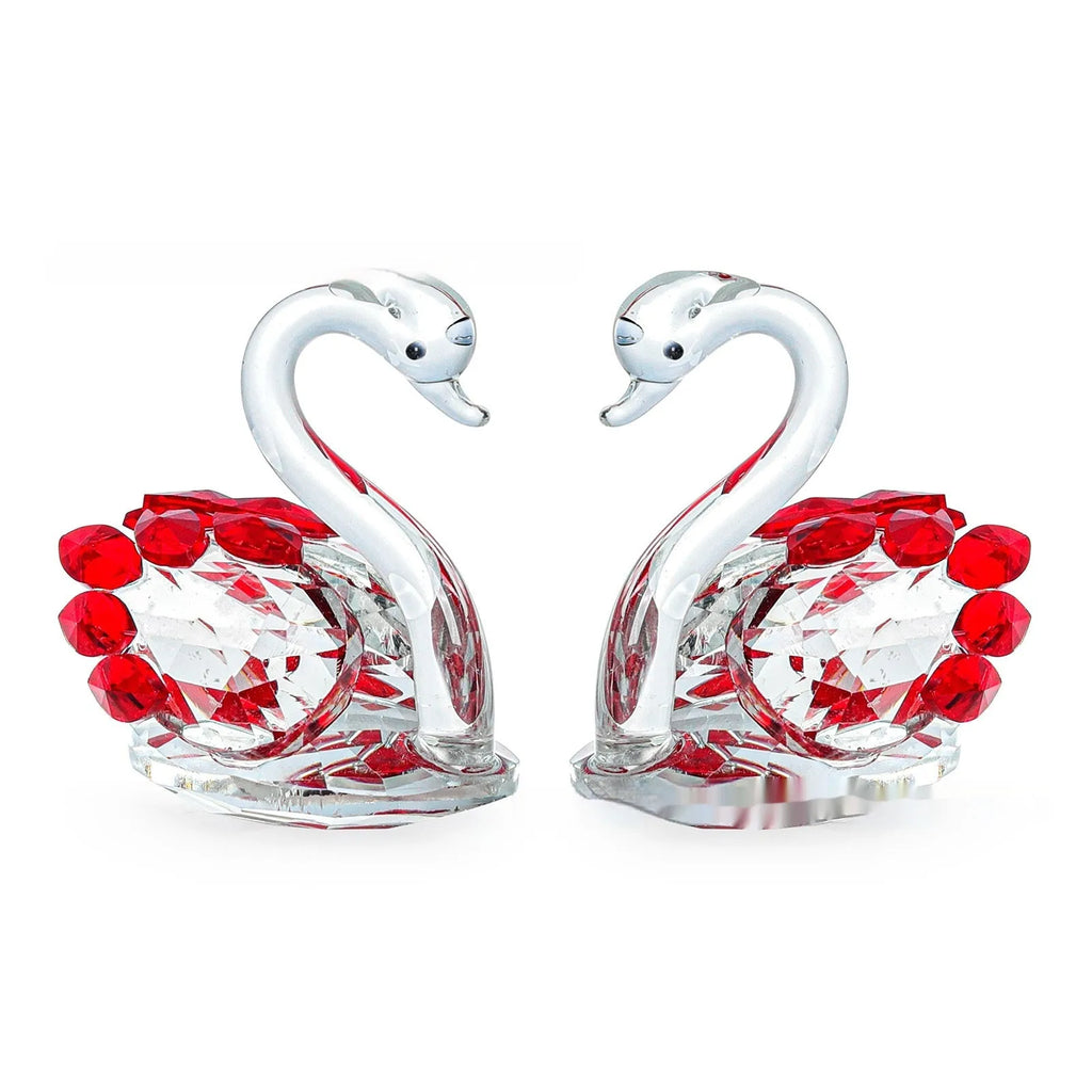 Clear crystal swan desktop ornament on a wooden surface