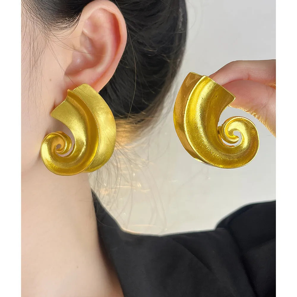 A pair of geometric-shaped alloy ear studs with a retro design, shown in gold and silver colours on a post backing.