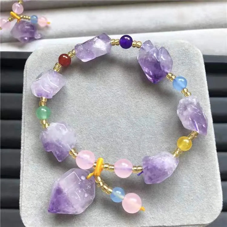 Close-up of a natural-shaped amethyst bead bracelet for women with a fu charm.