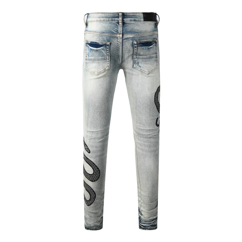 Blue distressed wash skinny jeans with a button fly and elasticated mid-rise waistband on a mannequin.