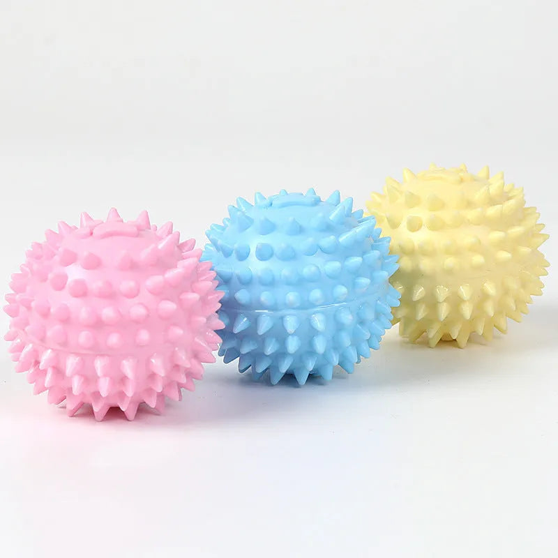 Close-up of 6cm TPR rubber dog chewing toy ball with footprint pattern in blue pink or yellow for tooth cleaning