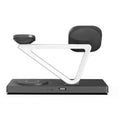 Black and white five-in-one wireless charging night lamp with magnetic phone bracket and circular base.