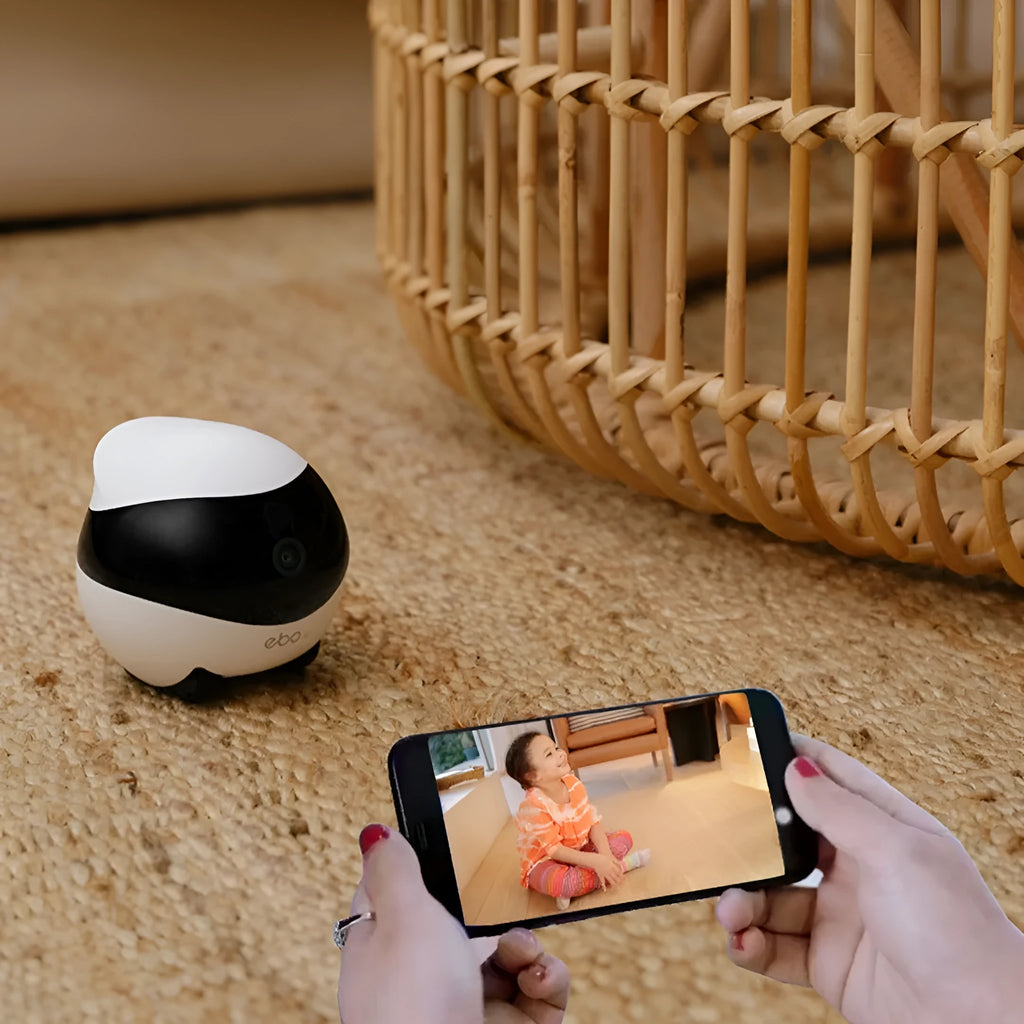 White smart home mobile robot surveillance camera with automatic charging dock