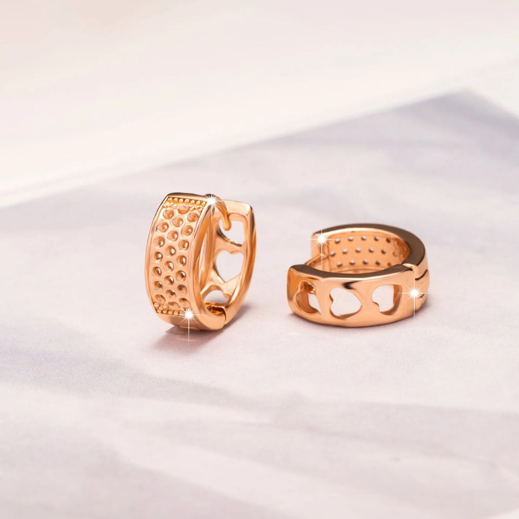 Rose gold electroplated women's earrings with hollow heart-shaped design and circular overall shape