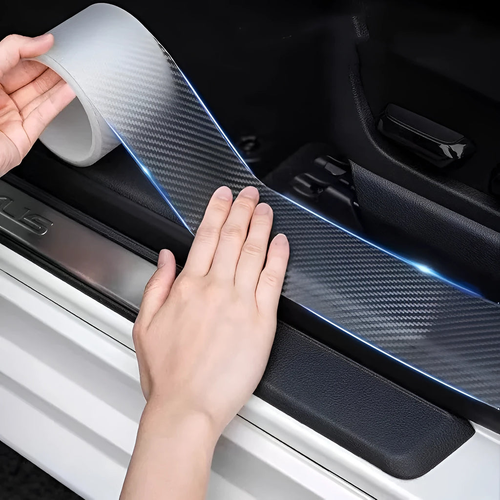Carbon fibre car door edge protection strip in transparent grain finish on a vehicle door