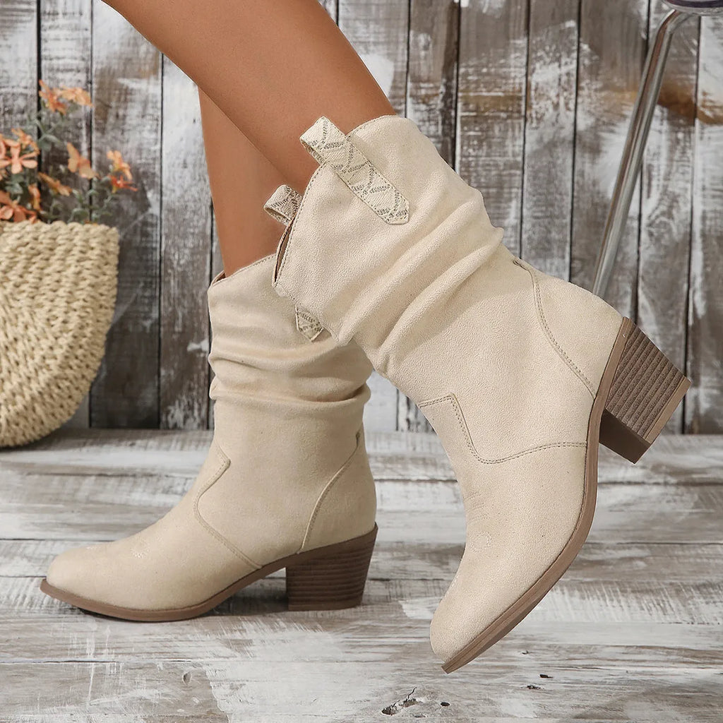 Milky white suede mid heel boots for women in plus sizes, showing leather stitching and a rubber sole.