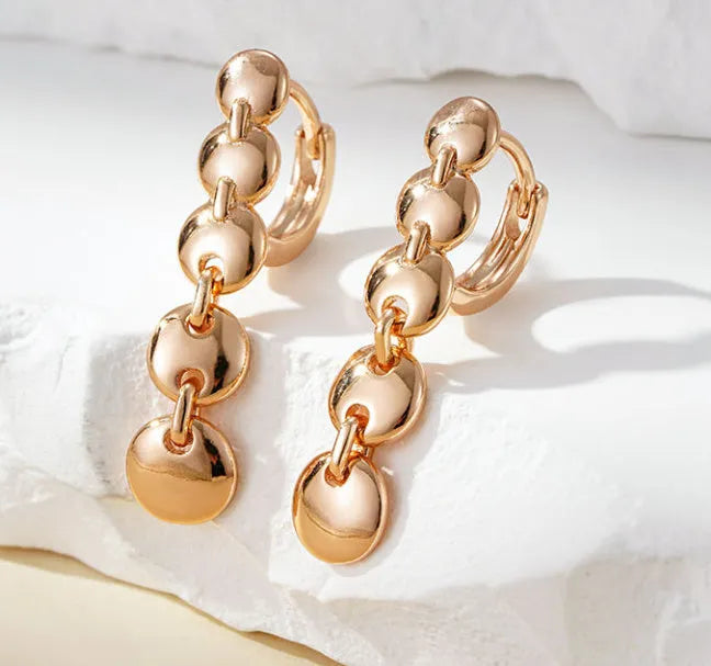 Gold retro long round circle drop earrings with woven wire construction.