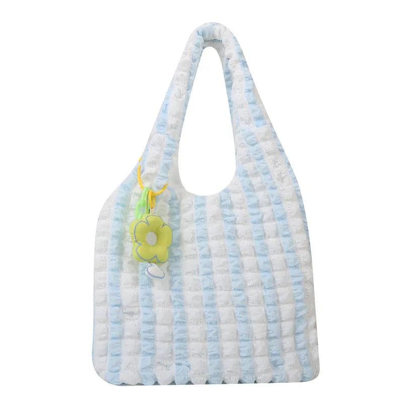 Pleated bubble bag in beige polyester with fold detailing, pendant, and cross-body strap