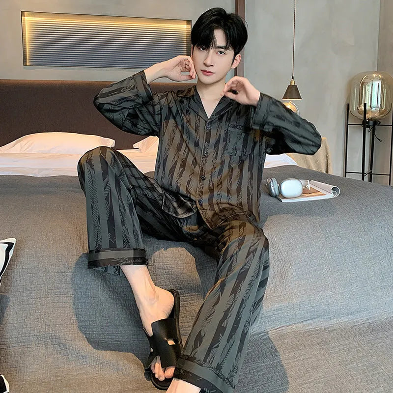 High-grade ice silk men's pyjama set V-neck long sleeve top and thin trousers in black stripes on a neutral background