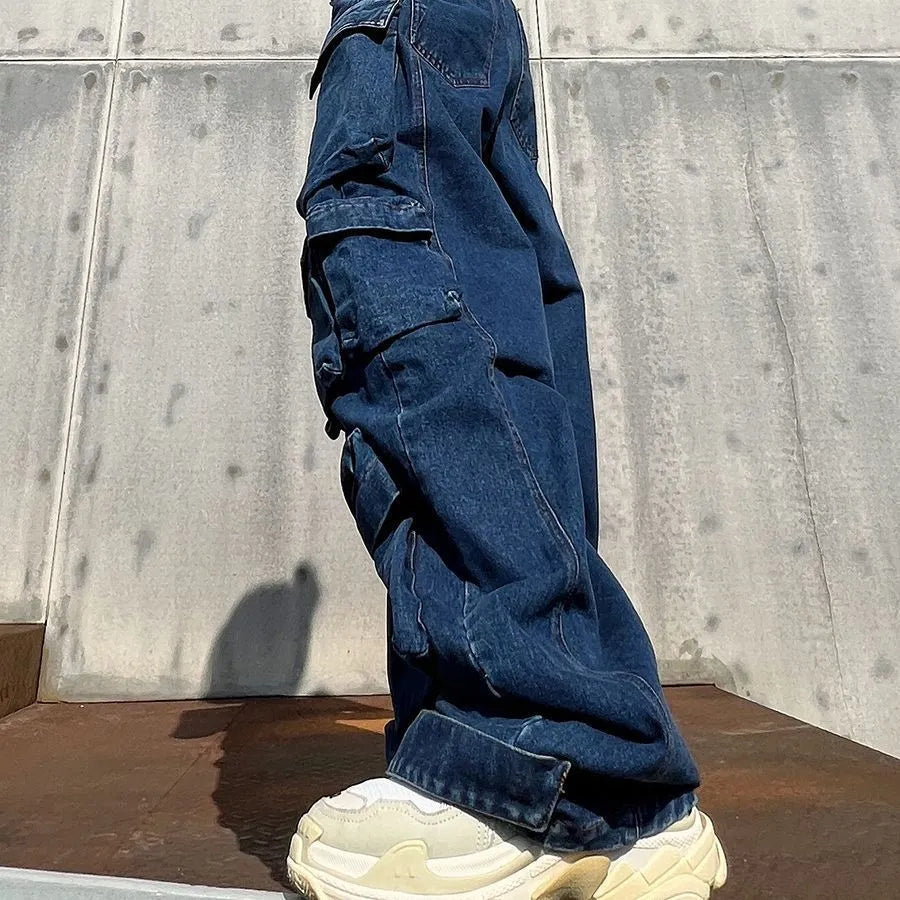 Dark blue distressed women's jeans with wide legs, high waist, and multiple pockets on a neutral background.
