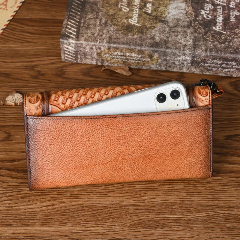 Chinese style embossed leather wallet in tri-fold design showing floral pattern on brown cowhide