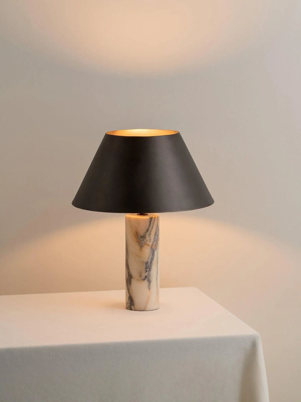 Black marble table lamp with modern minimalist design on wooden surface
