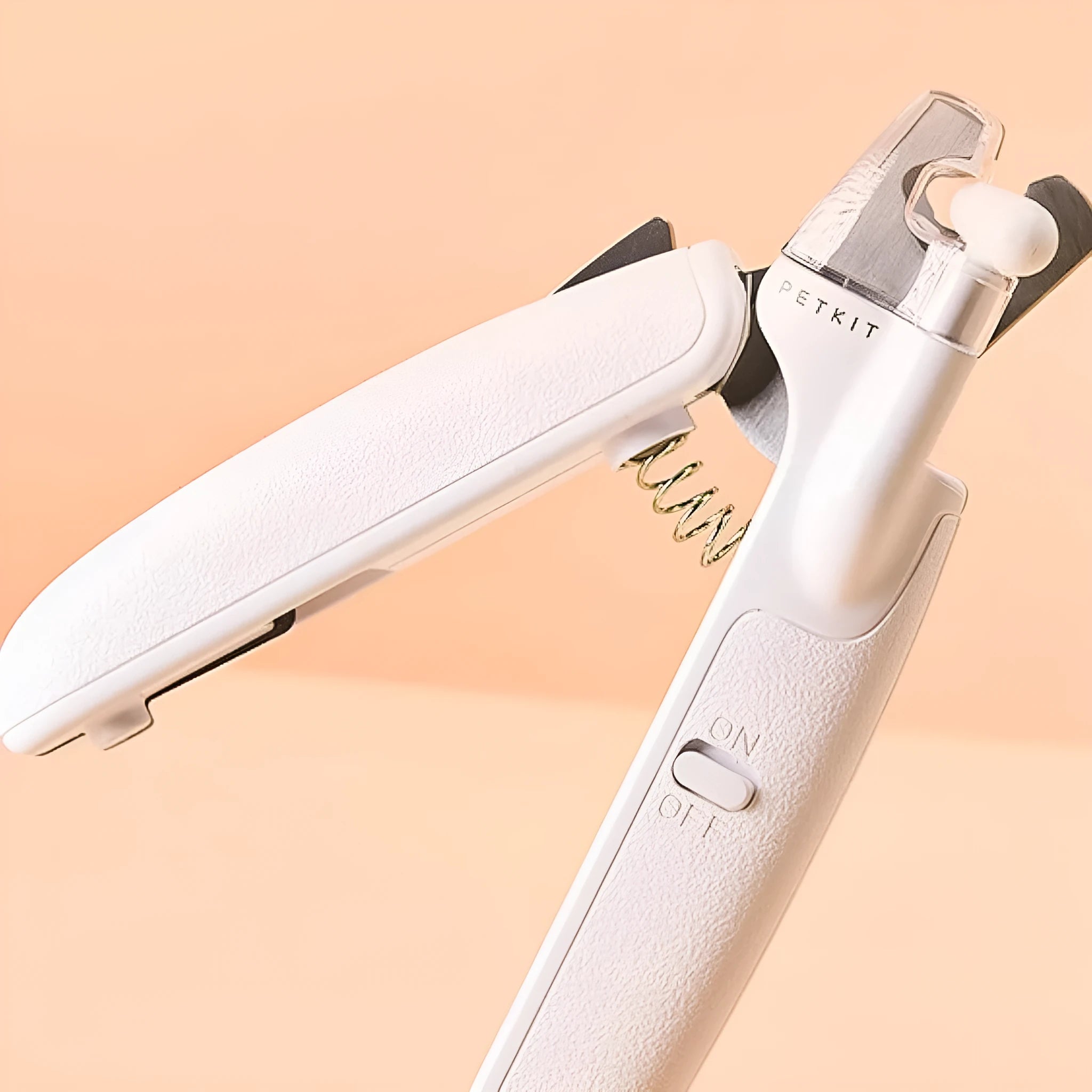 White pet nail clippers with LED light, triangular blade, and transparent anti-splash guard