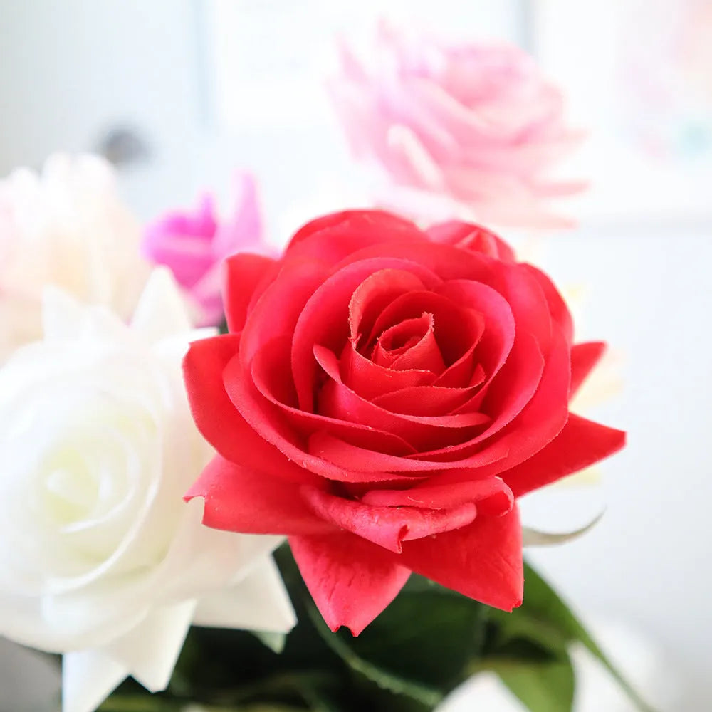 Artificial silk flower bouquet with red petals and green leaves measuring 42cm long