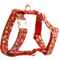 Red background snowflake plaid Christmas pet collar leash set with bowknot flowers and dog vest on a small dog