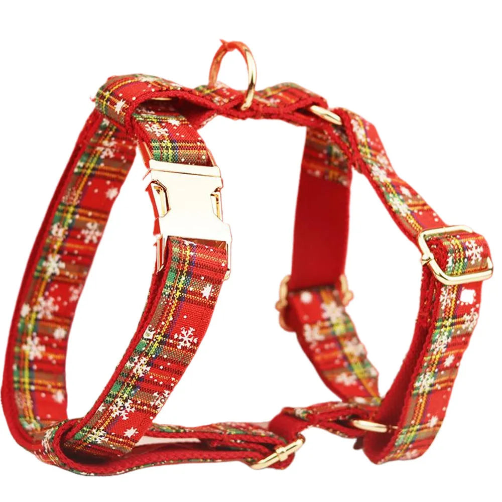 Red background snowflake plaid Christmas pet collar leash set with bowknot flowers and dog vest on a small dog