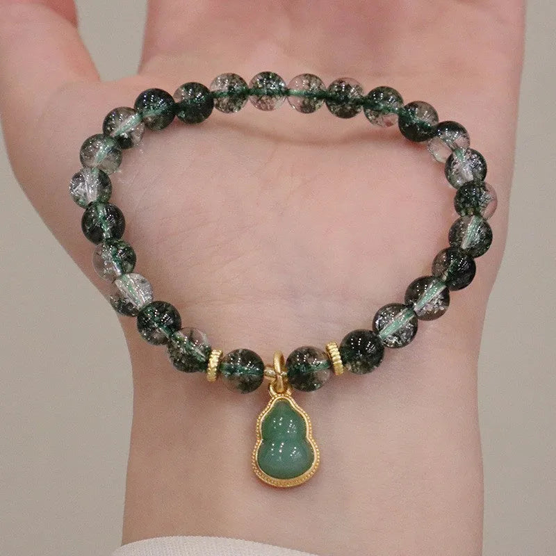 Natural green phantom quartz heart pendant women's crystal bracelet with pearl accents on white background