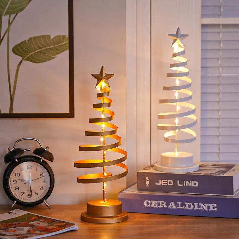 LED Christmas tree spiral light ornament with warm white glow on a table, gold finish