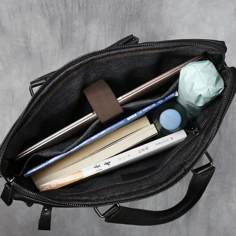 Black men's leather leisure briefcase with top layer cow hide, zipper closure, and shoulder strap