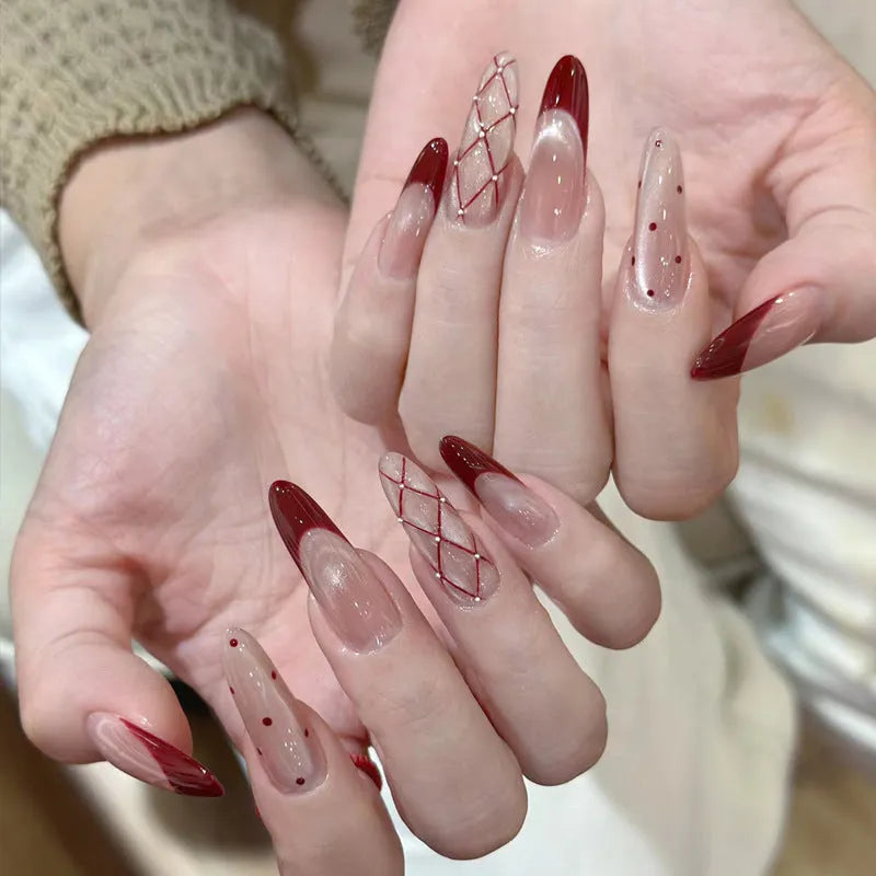 Set of short, colourful fake nails for girls with adhesive tabs on a pink background.