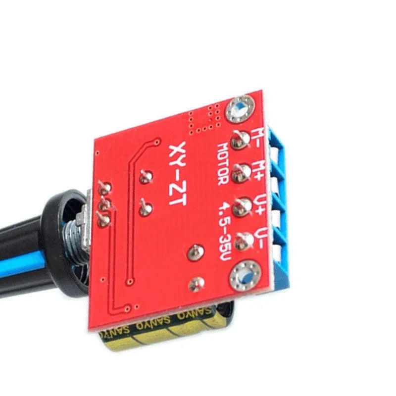 Small green PCB DC motor governor with black potentiometer knob for 5V-35V speed control