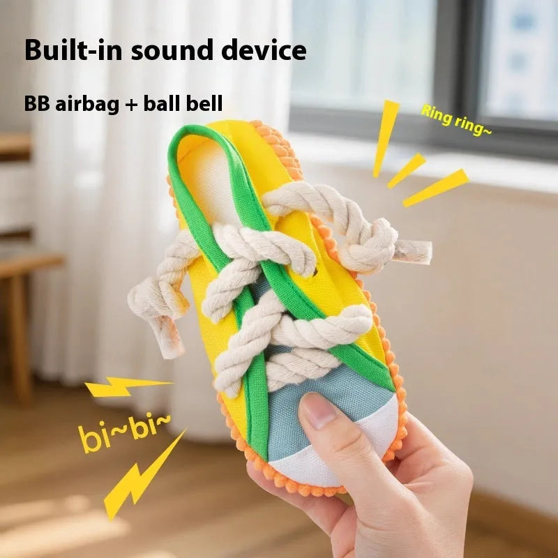 Yellow plastic dog chew toy shaped like a slipper with a squeaker.