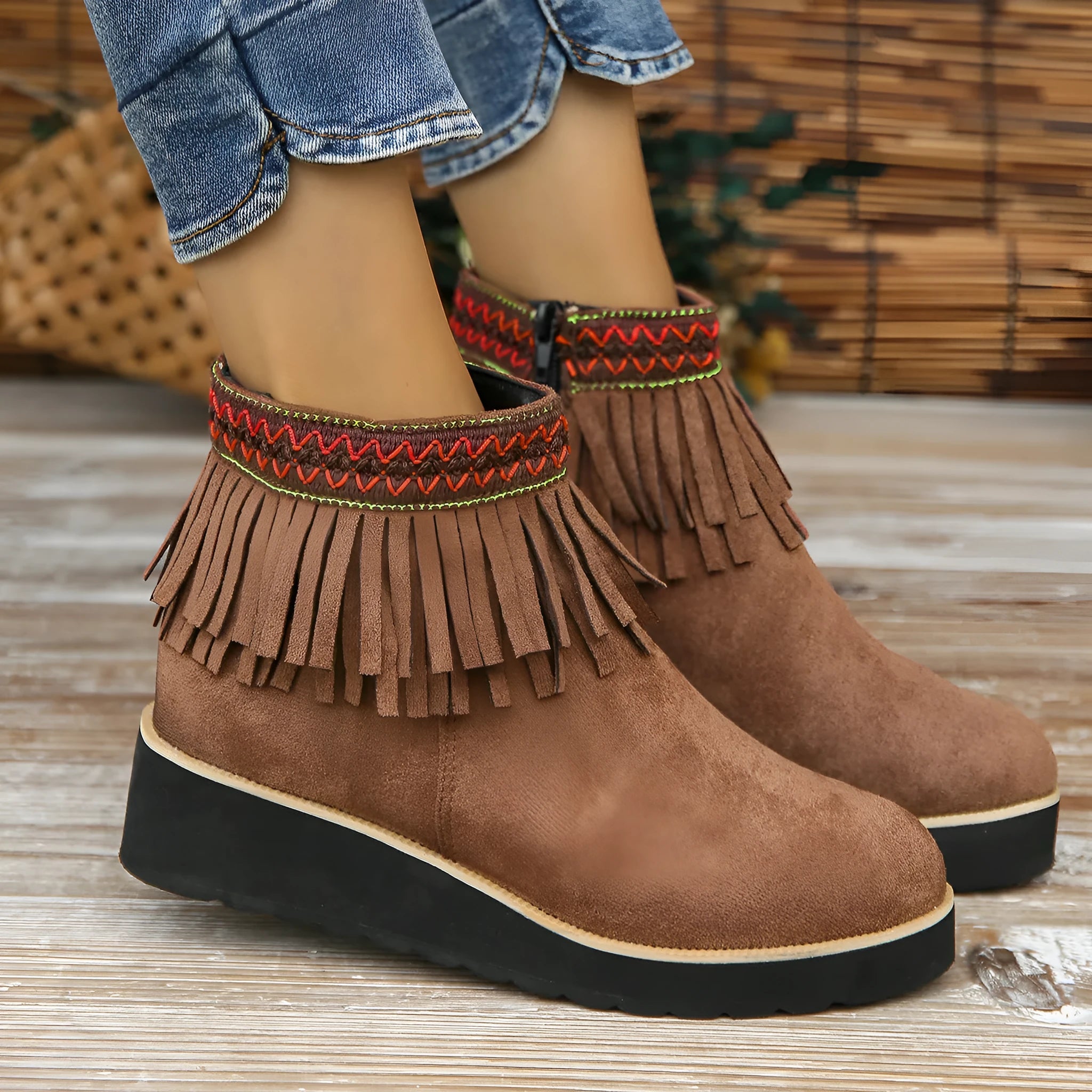 Women's suede wedge booties with side zipper, thick rubber sole, and tassel detail in black colour