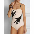 Women's one-piece bikini swimsuit with a gauze skirt, shown on a model.