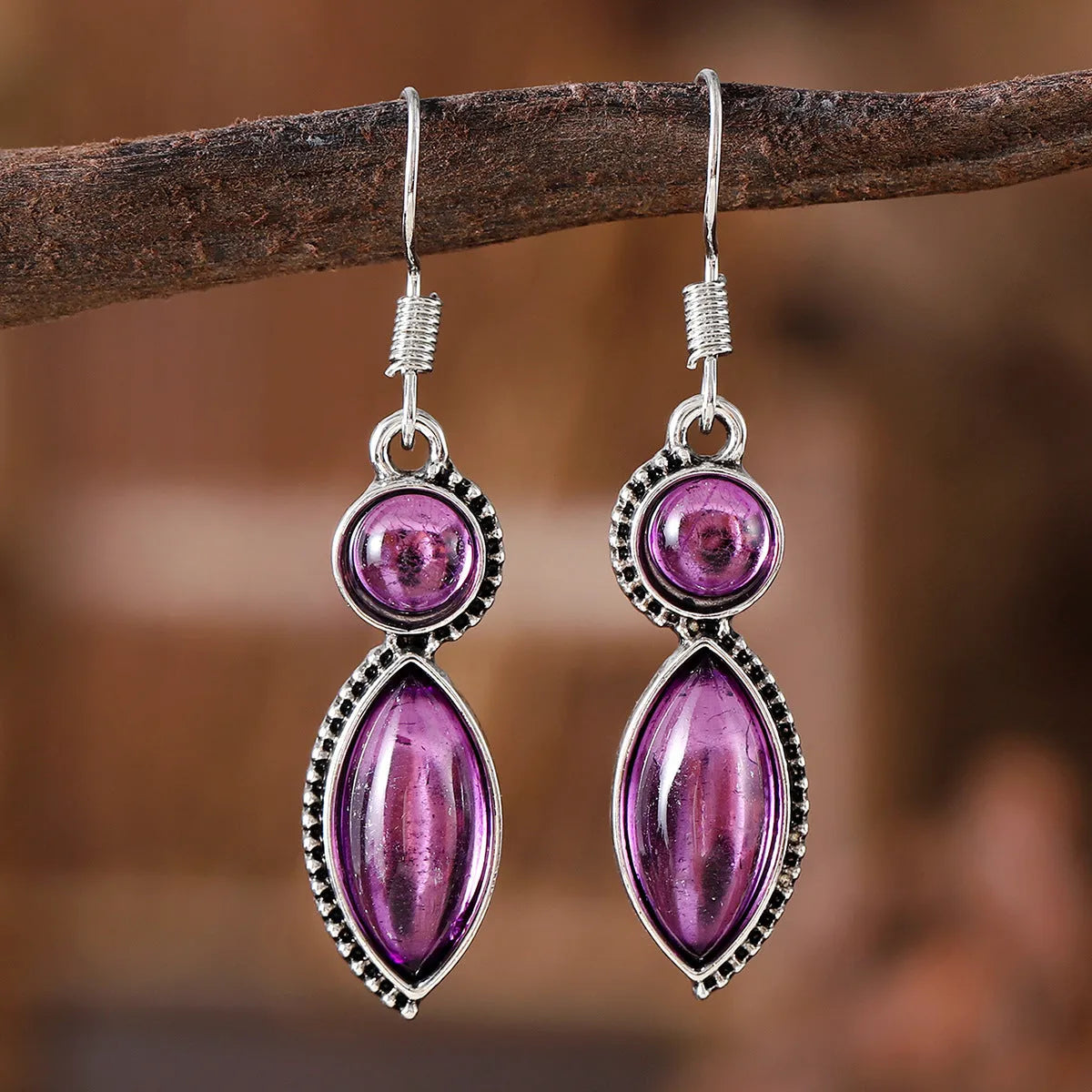 Pair of black and purple geometric vintage pendant earrings with round decorative elements