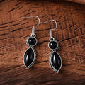 Pair of black and purple geometric vintage pendant earrings with round decorative elements