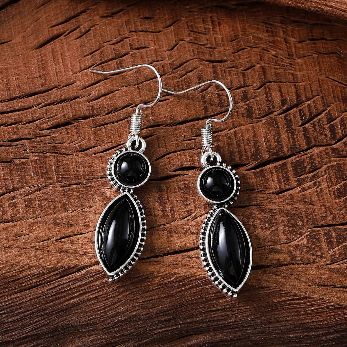 Pair of black and purple geometric vintage pendant earrings with round decorative elements