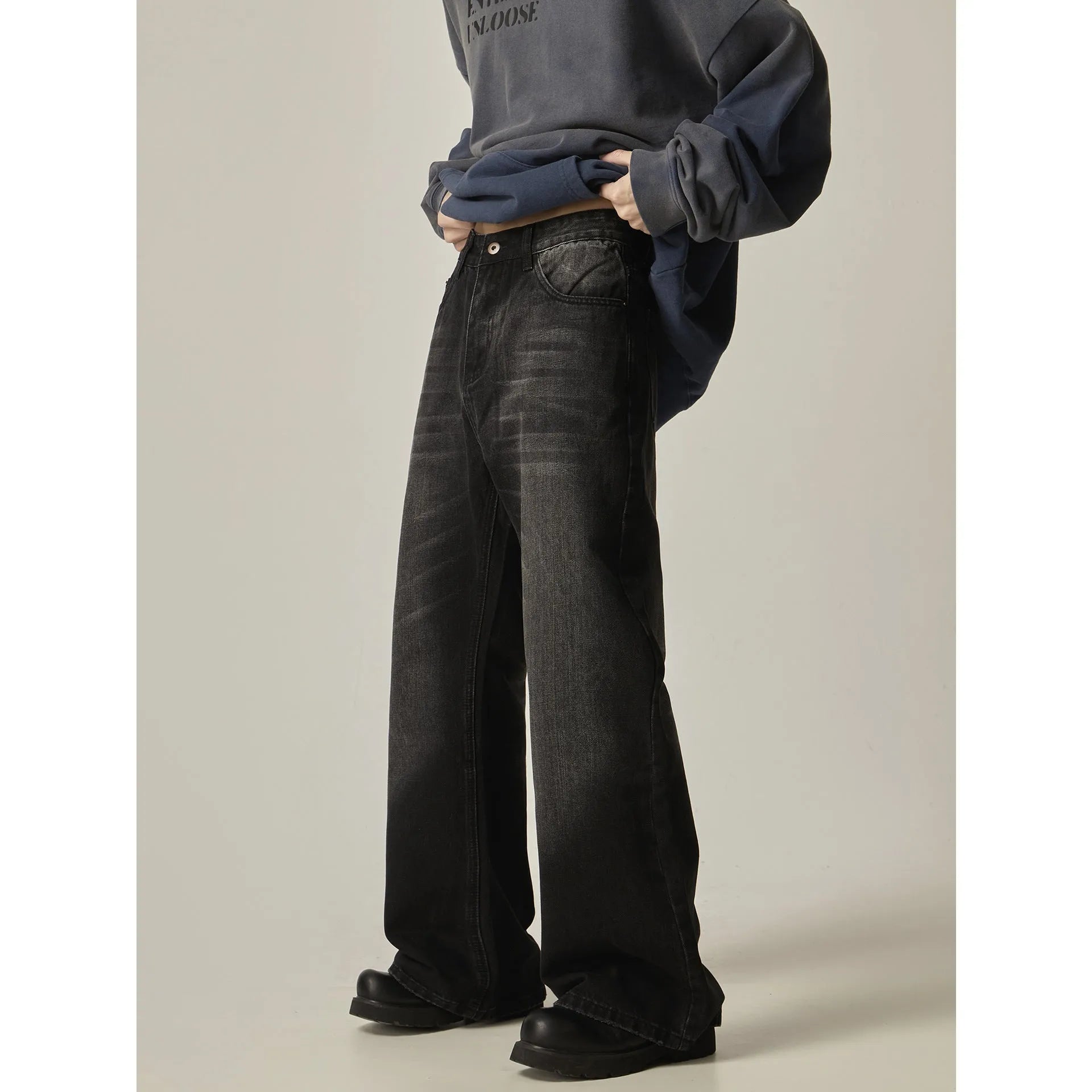 Men's black loose straight jeans with retro styling and zipper fly